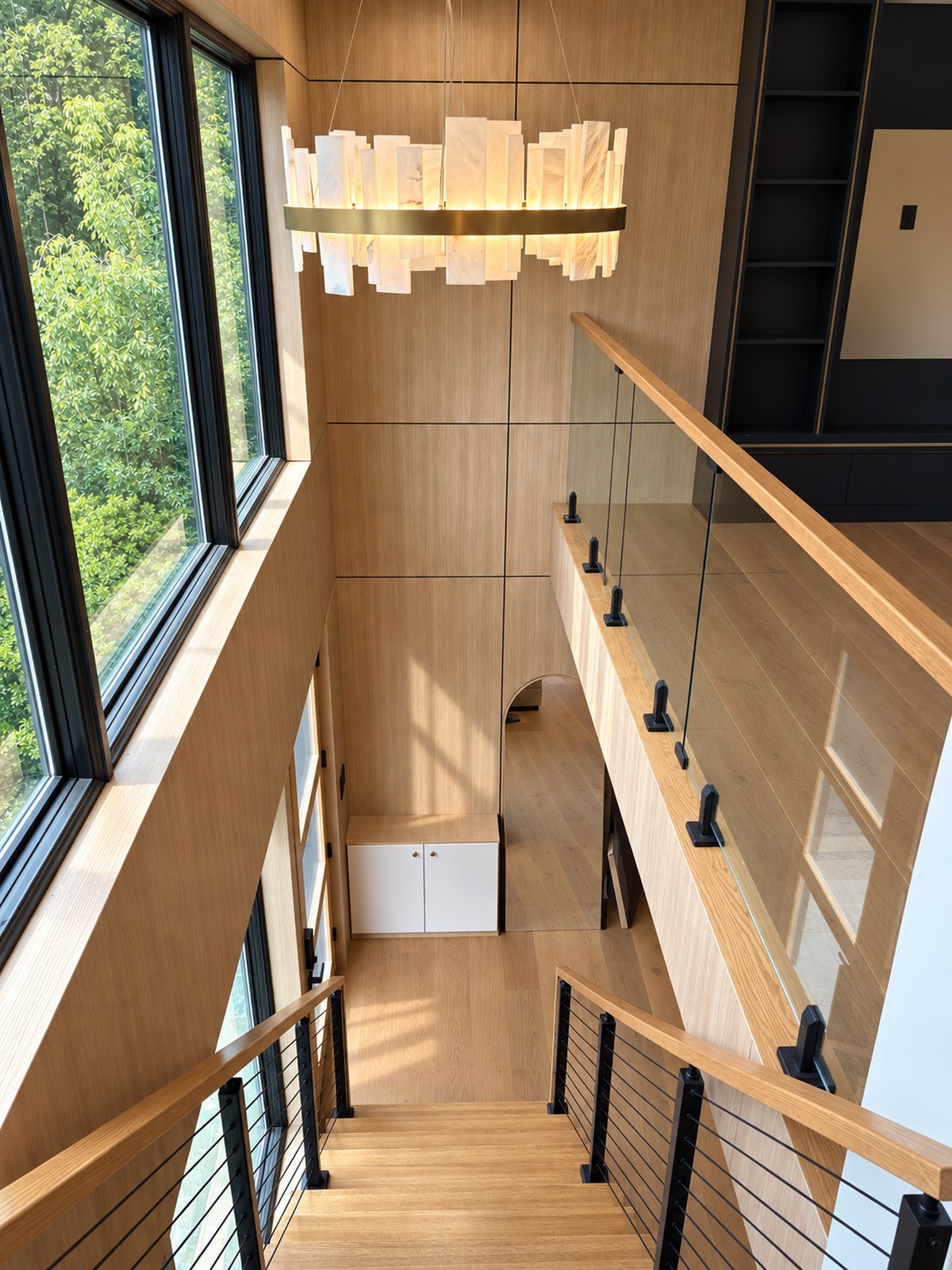 Daylit oak and glass stairwell connecting a renovated home
